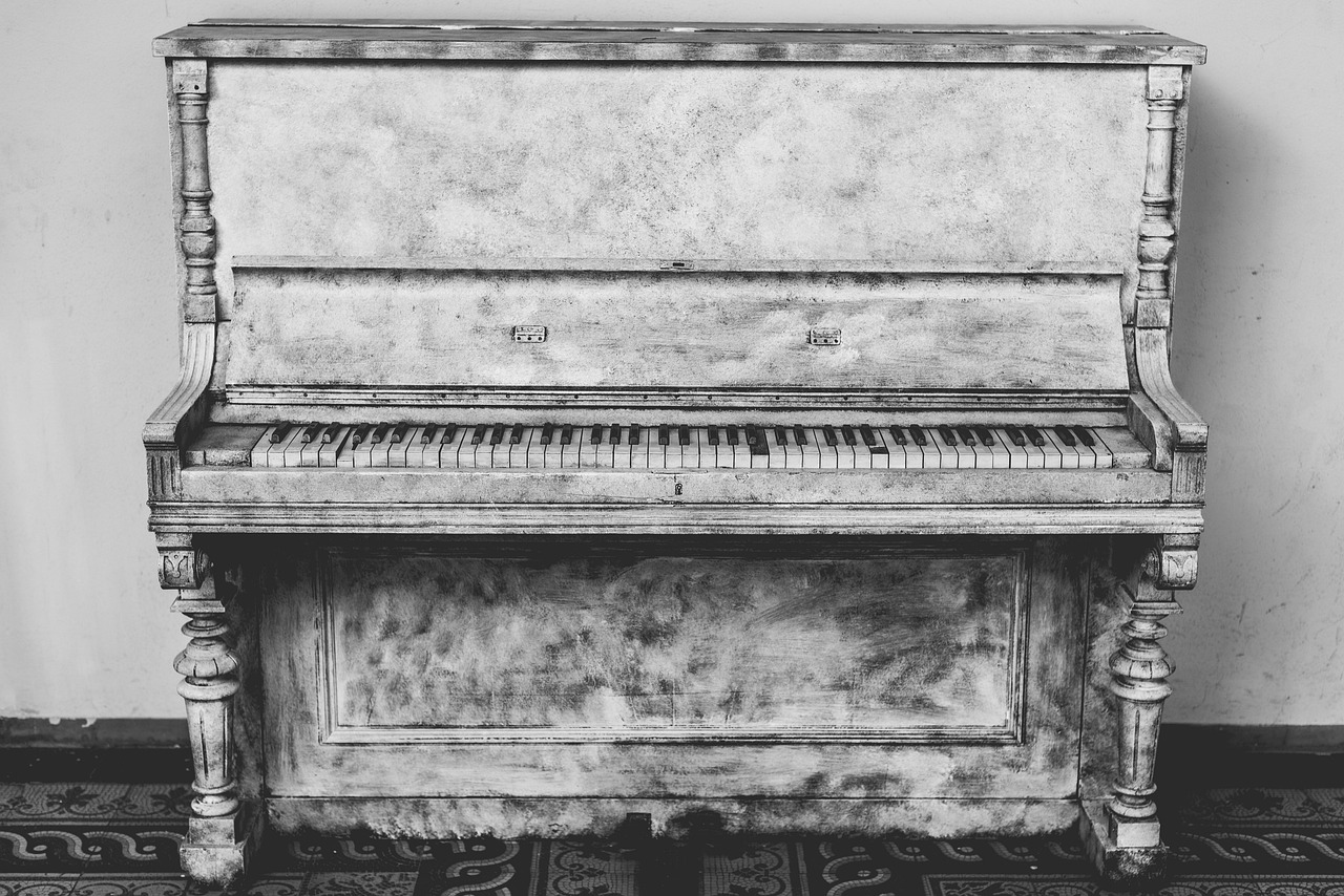 movers handling upright piano